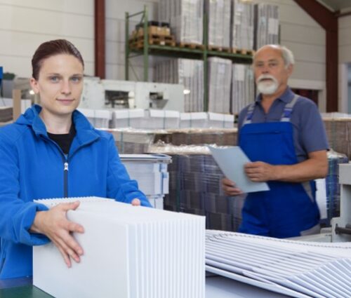 Factory workers working with cardboard